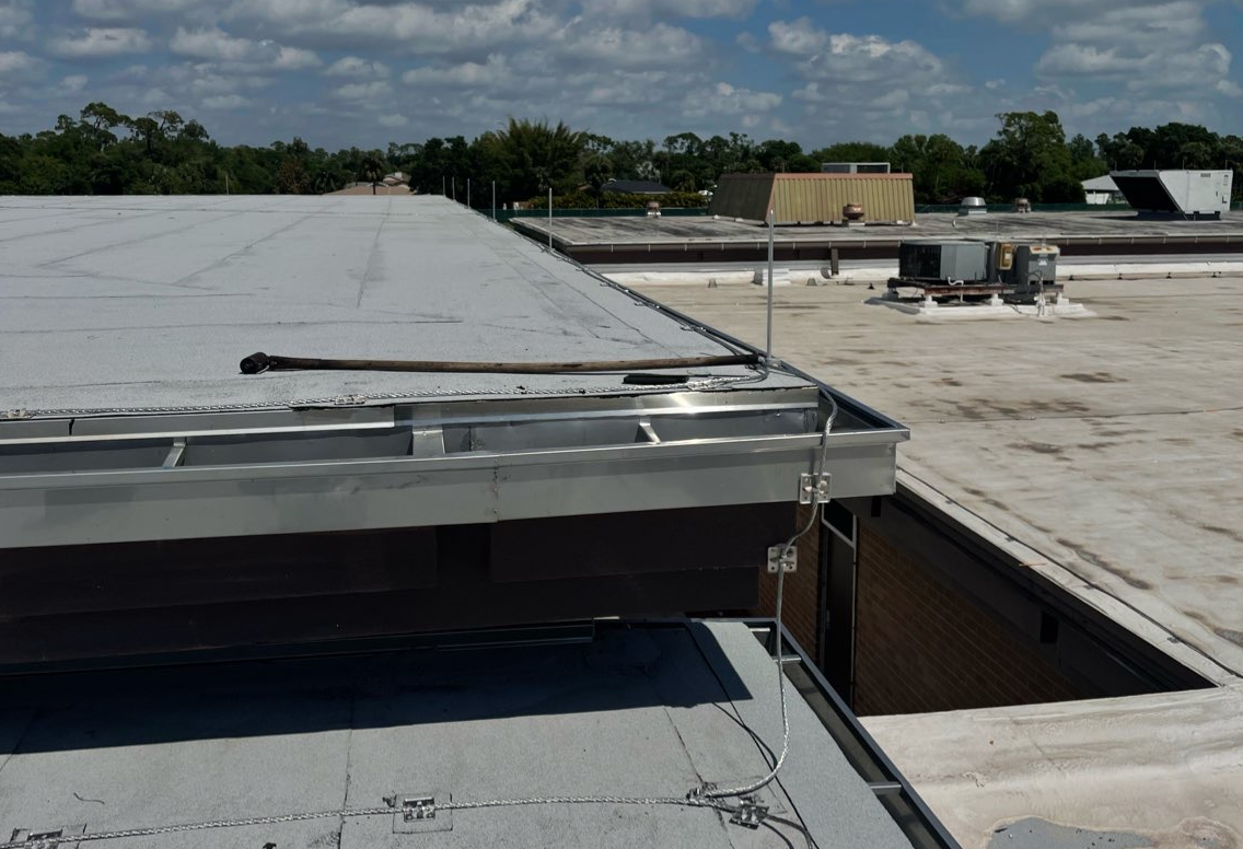 Aged commercial roofing showing sun and storm exposure during a Florida inspection