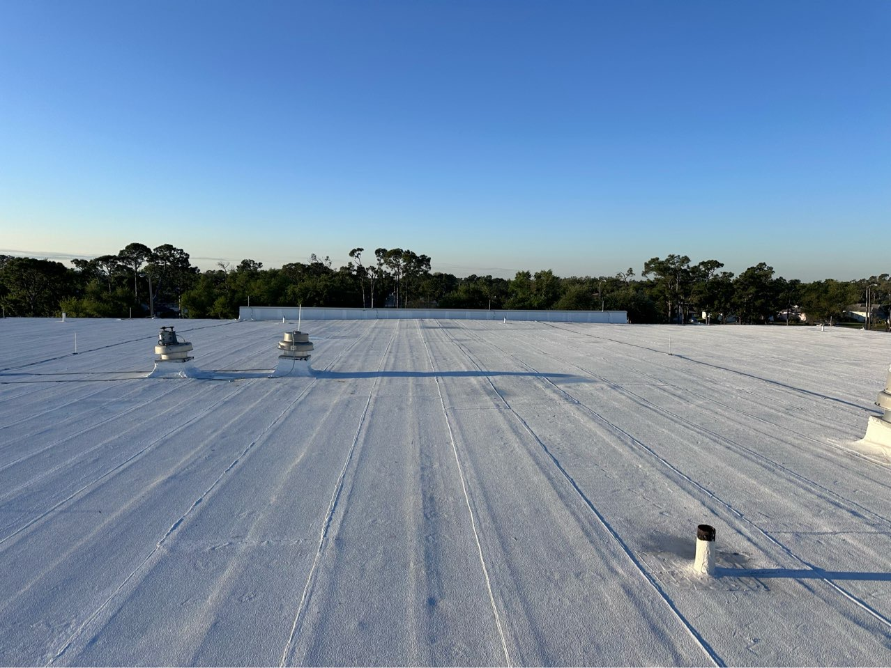 Storm damage to rooftop flashing and penetration seals on a commercial building