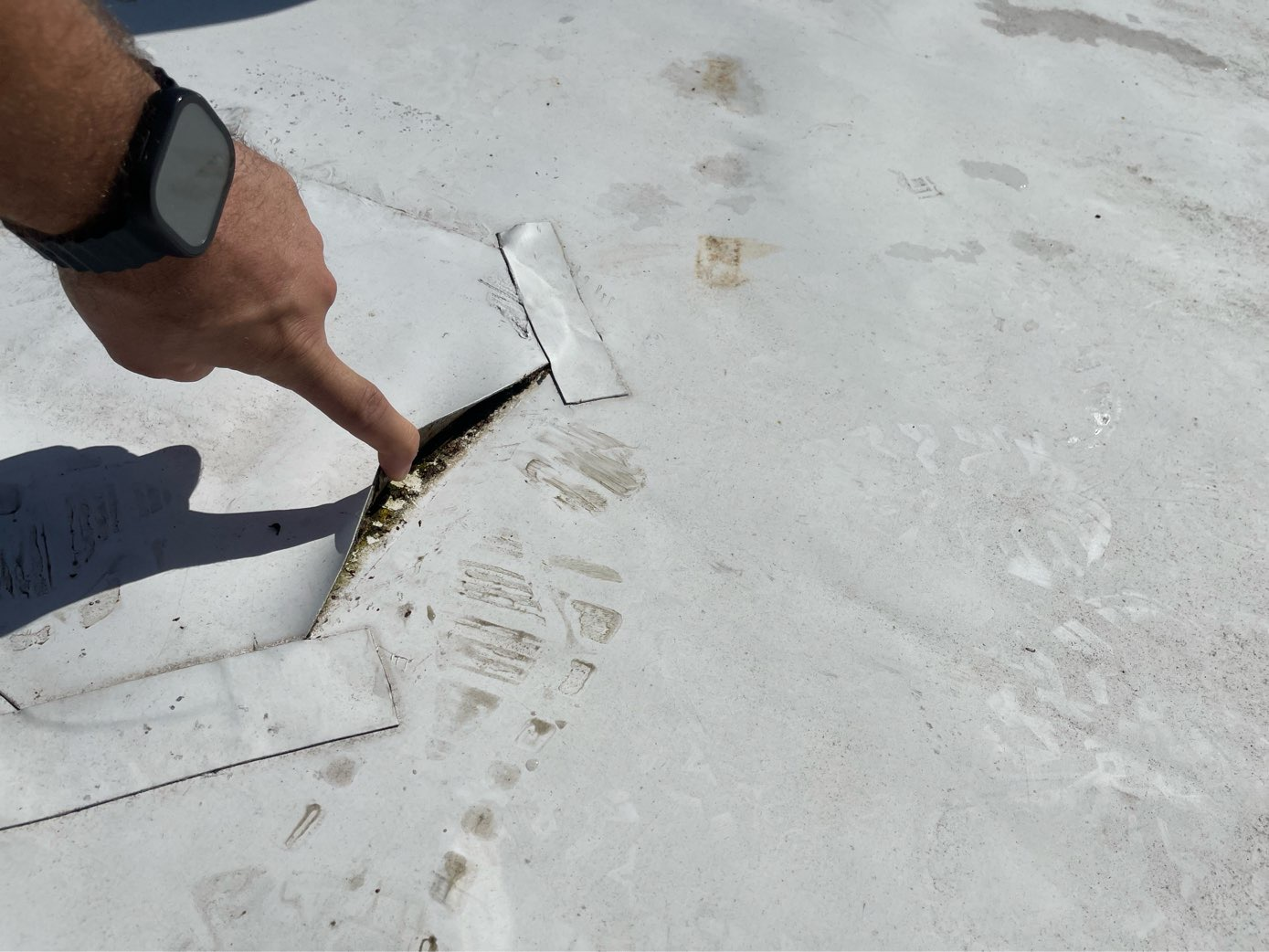 Aged commercial roofing surface impacted by Florida storm conditions